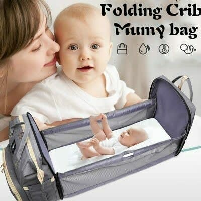 Diaper bag that converts to bassinet top